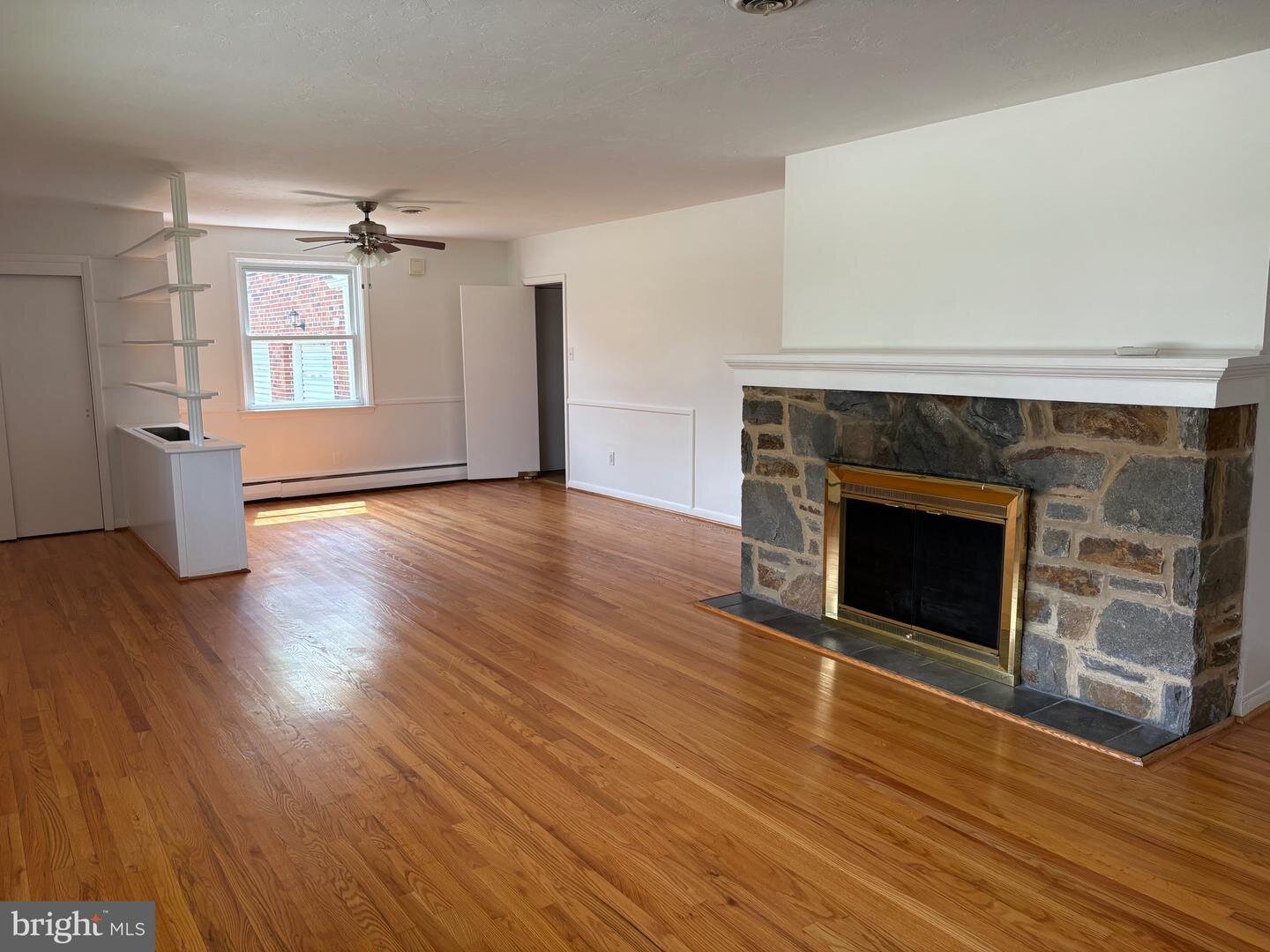 Living room with refinished flooring and fireplace at 1215 Milltown Road