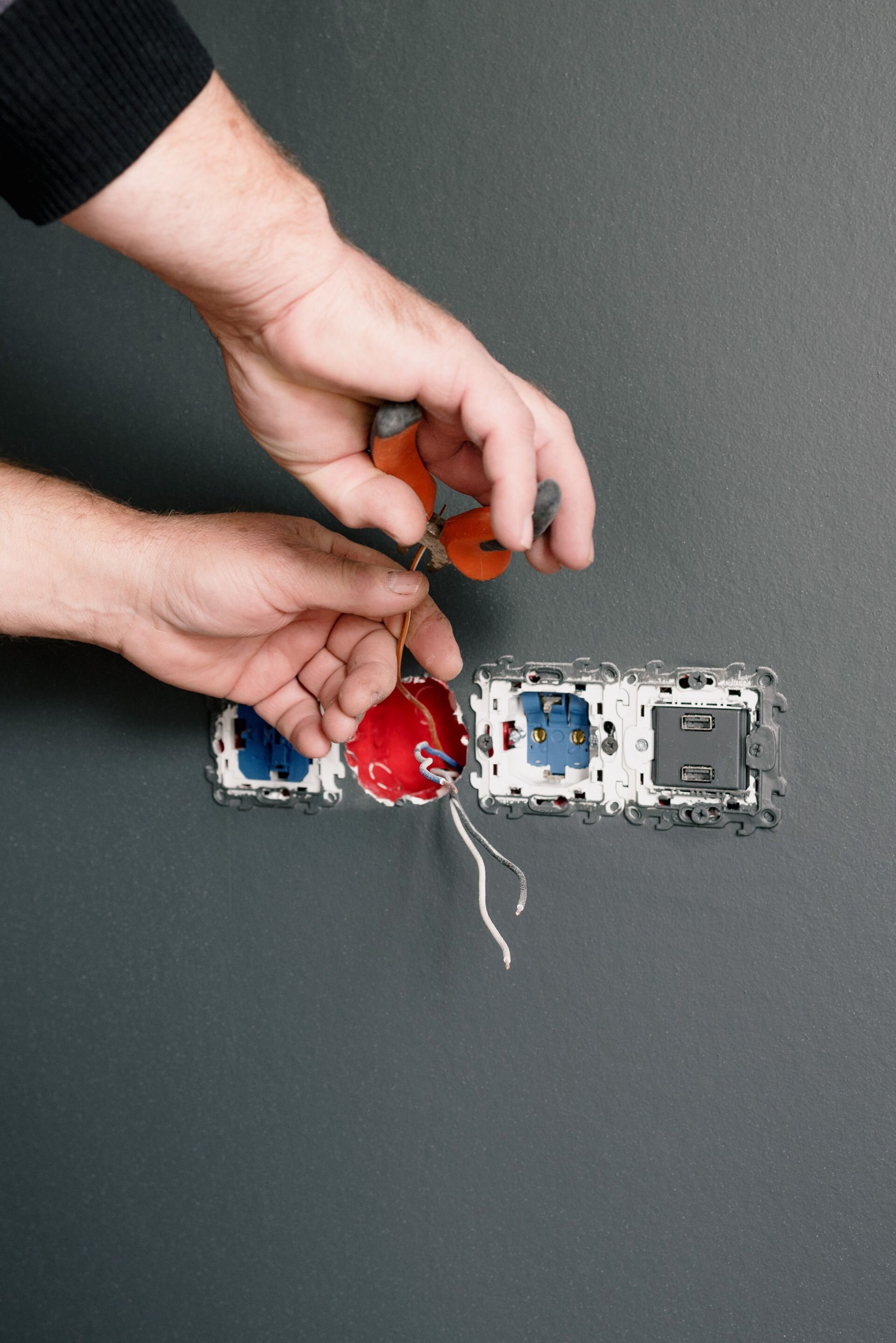 Cafe Bartique technician wiring an outlet