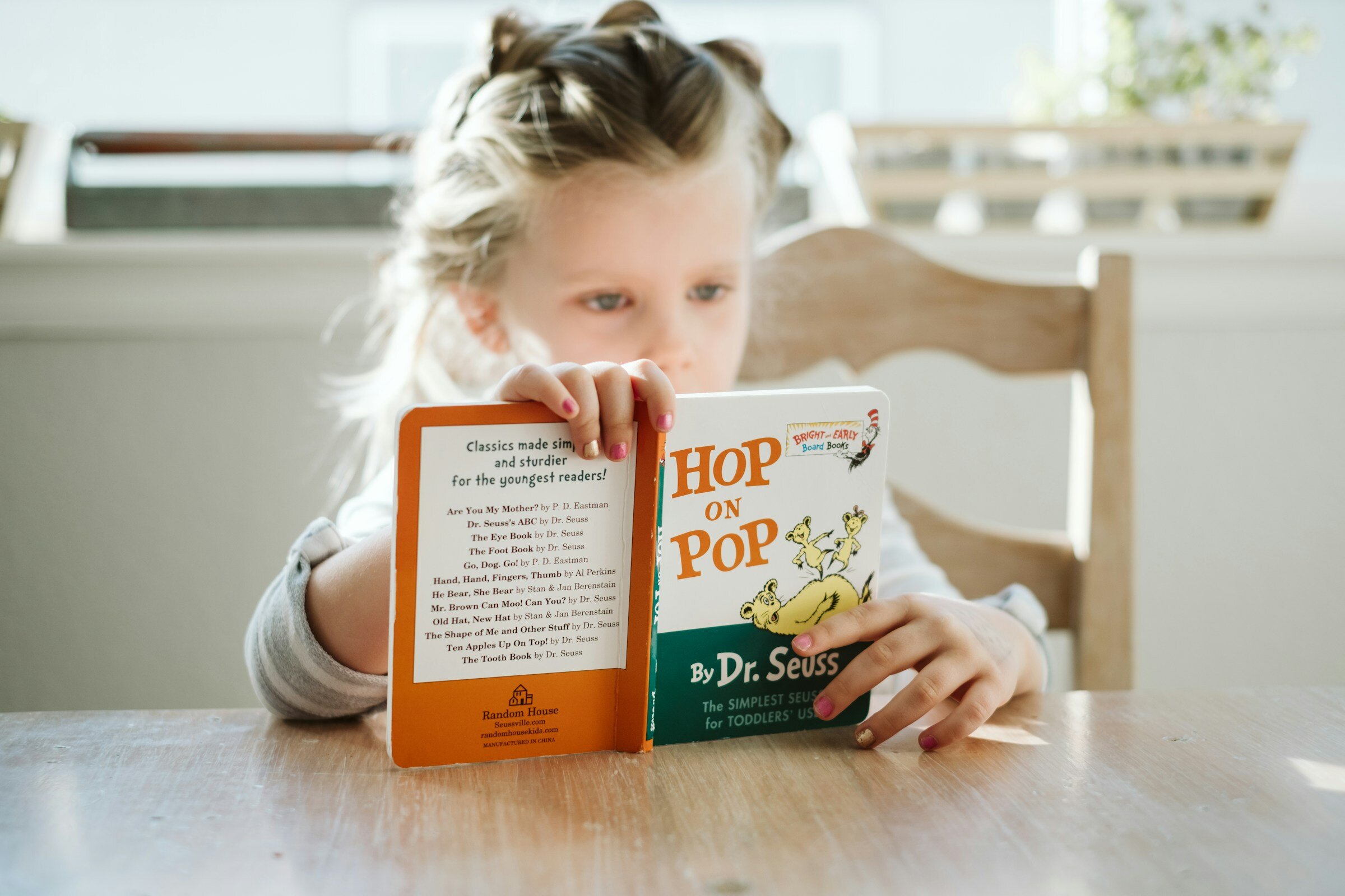 Child reading a Dr. Seuss book