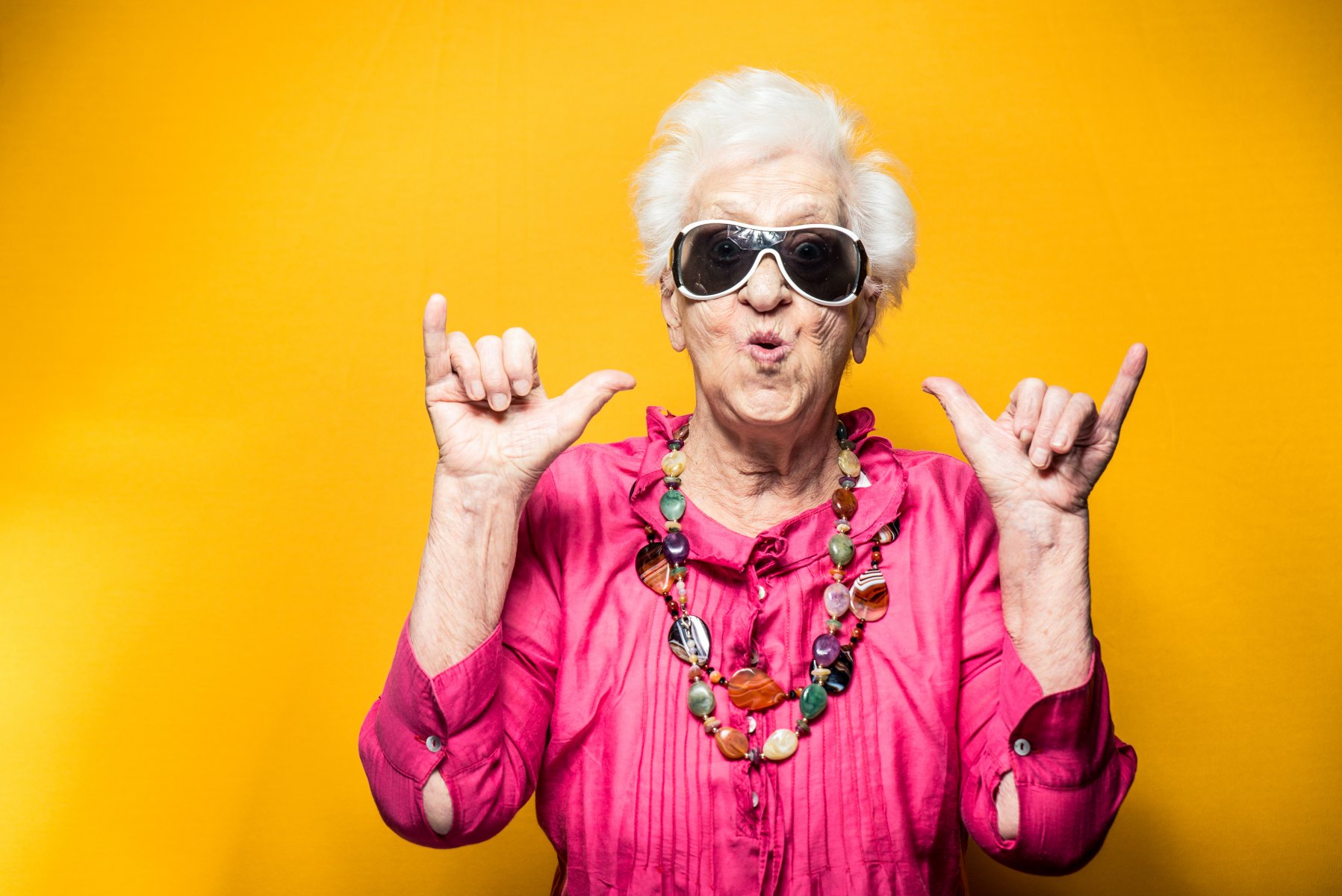 older woman celebrating hand gestures