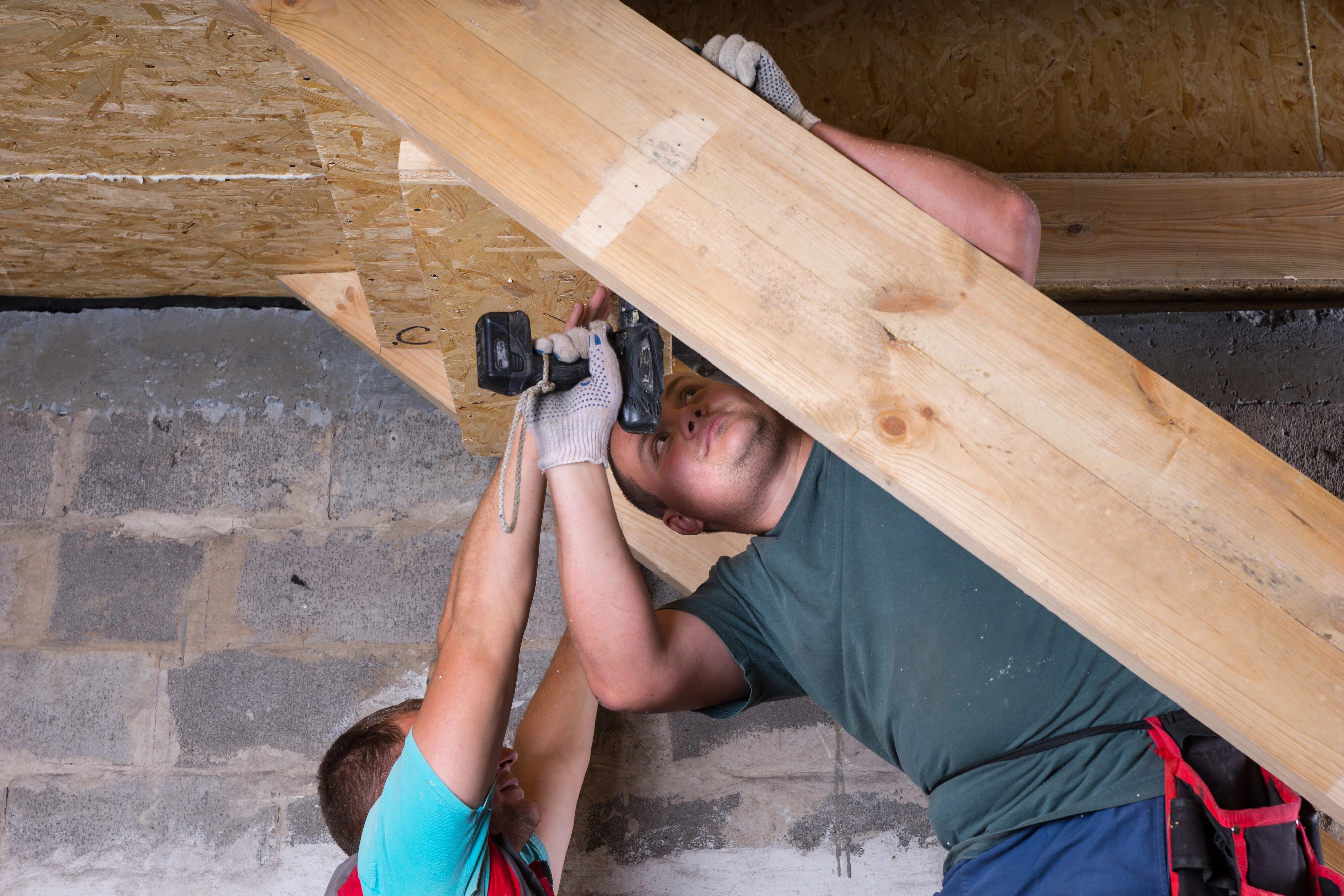 Mr. Junk Removal worker finishing a basement
