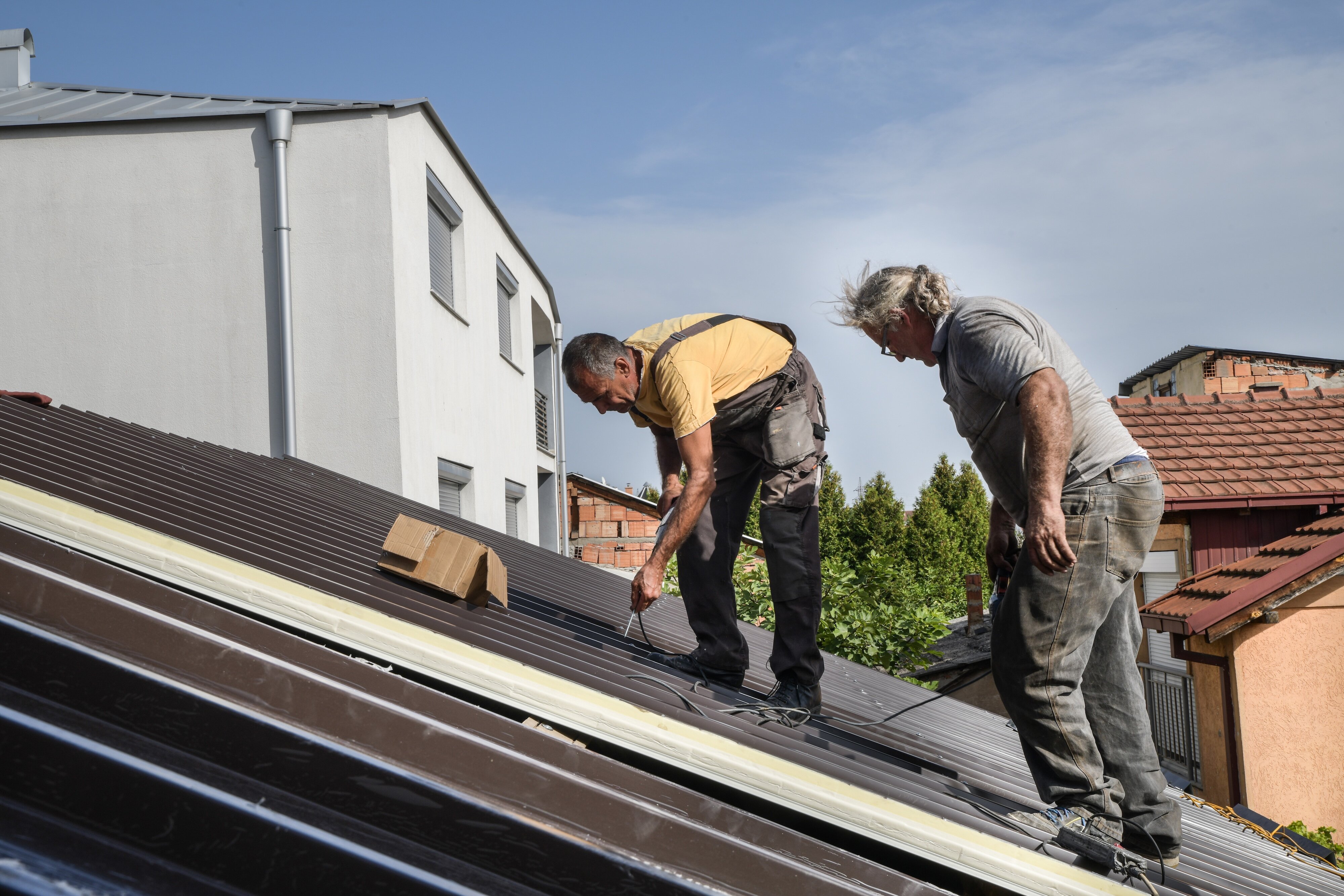 roofers working on a roof in [market city]